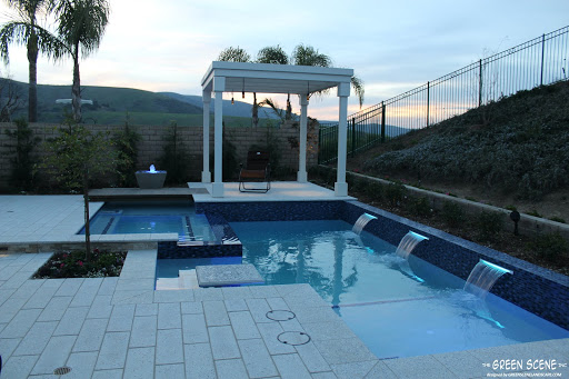 a built-in pool table in a contemporary pool design at sunset