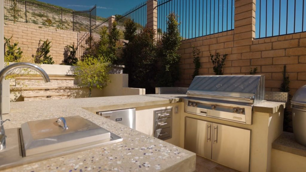 Outdoor kitchen with grill and recycled glass countertop