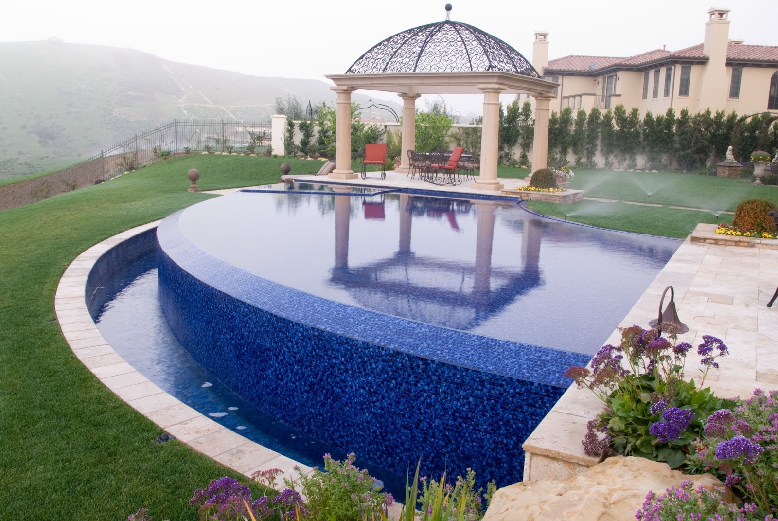 A swimming pool and a lawn uses more water